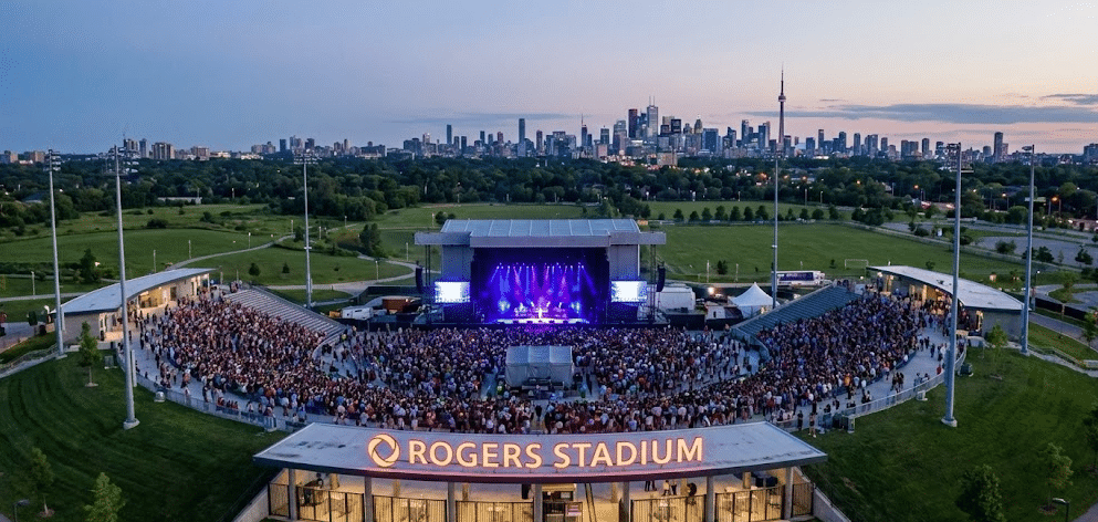 Exterior view of the Rogers Stadium entrance in North York Toronto, showing the illuminated stage and seating for a high-end outdoor concert event