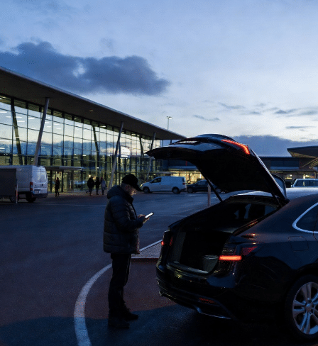 a car at an early morning airport terminal