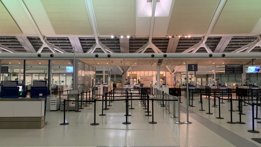 Airport check-in hall with queue lines before security