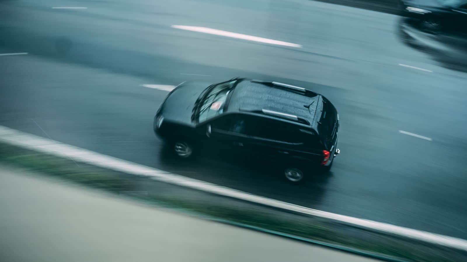 Black SUV driving on a highway