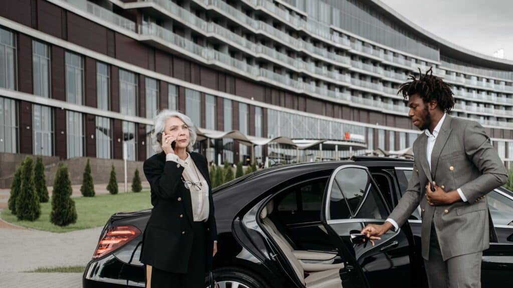 Chauffeur holding the car door for a business traveller