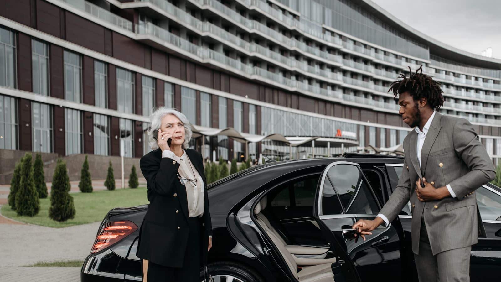 Chauffeur holding the car door for a business traveller