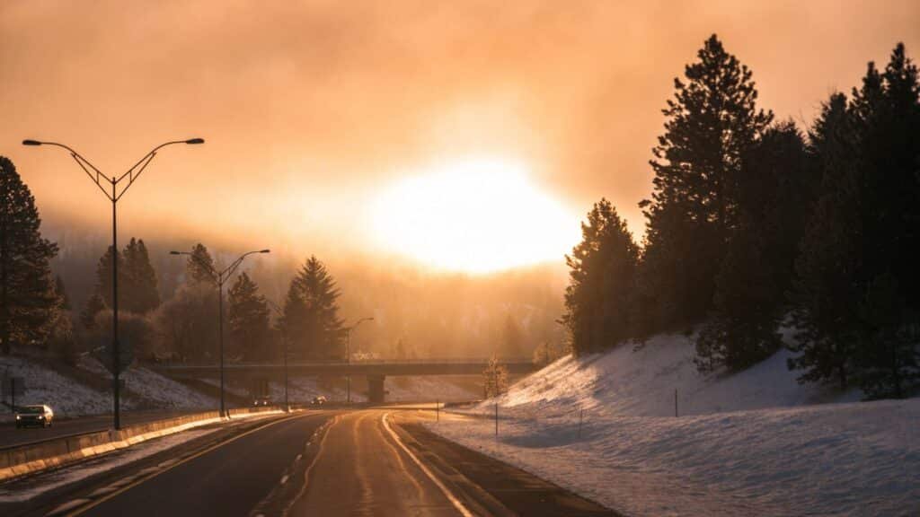 Snowy highway at sunrise in winter